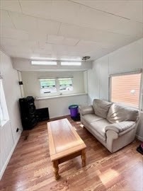 1515 VFW Parkway, Unit M19 Boston, MA 02132 - Photo 5 of 13 a living room with furniture and a large window