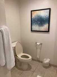 a white toilet sitting next to a bathroom