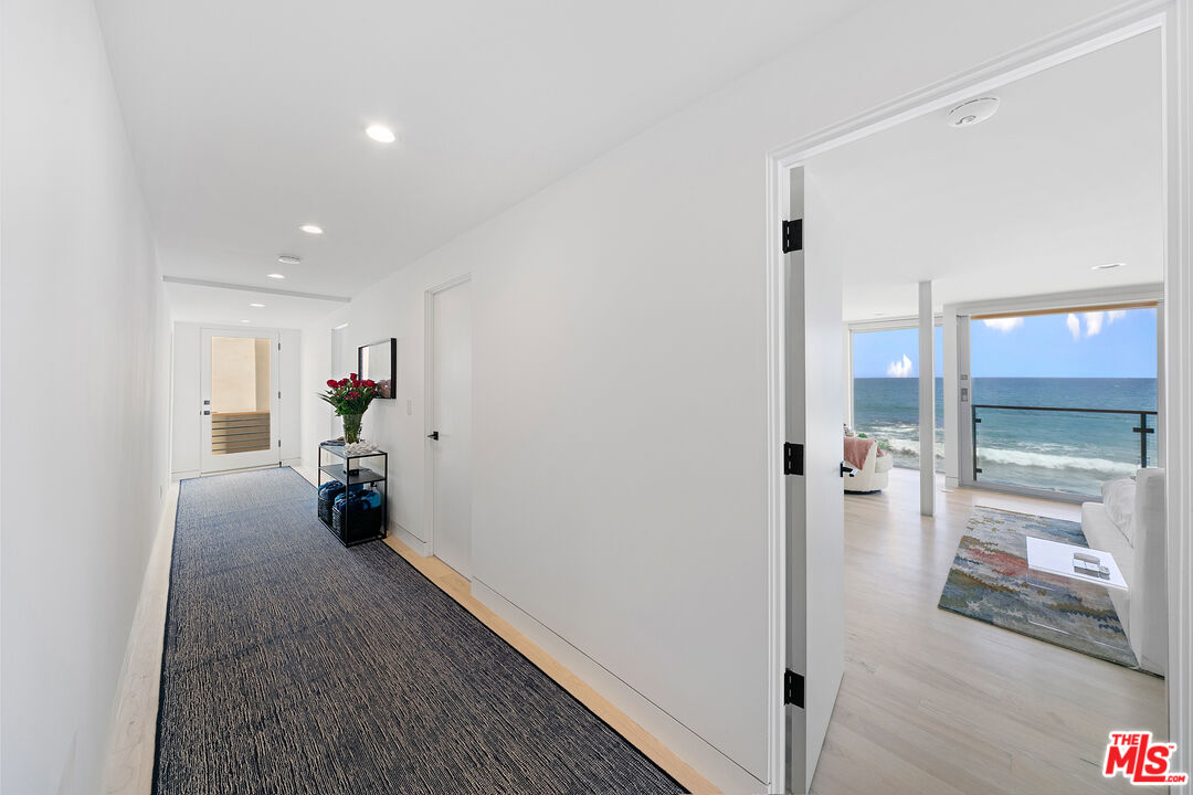24928 Malibu Road Malibu, CA 90265 - Photo 15 of 50 a view of a hallway with closet and a couch