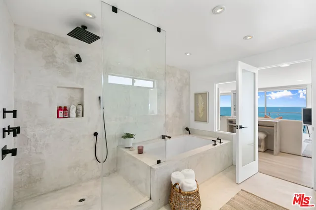 a bedroom with a bed and view of living room