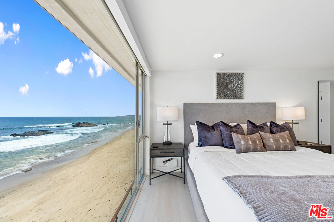 24928 Malibu Road Malibu, CA 90265 - Photo 22 of 50 a bedroom with a bed and a large window