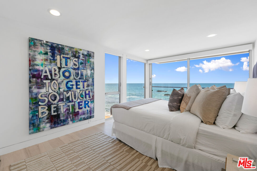 24928 Malibu Road Malibu, CA 90265 - Photo 23 of 50 a bedroom with a bed and a painting on the wall