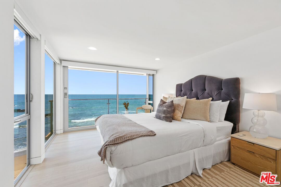 24928 Malibu Road Malibu, CA 90265 - Photo 24 of 50 a large bedroom with a bed and large window