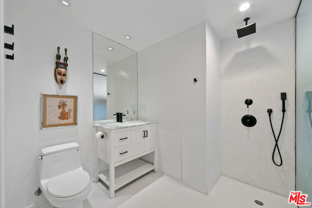 24928 Malibu Road Malibu, CA 90265 - Photo 30 of 50 a bathroom with a toilet sink vanity and shower