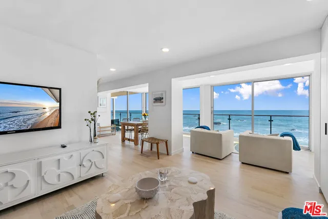 a bedroom with a bed and a potted plant