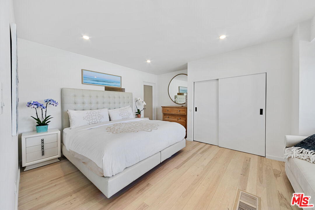 24928 Malibu Road Malibu, CA 90265 - Photo 39 of 50 a bedroom with a bed and a potted plant