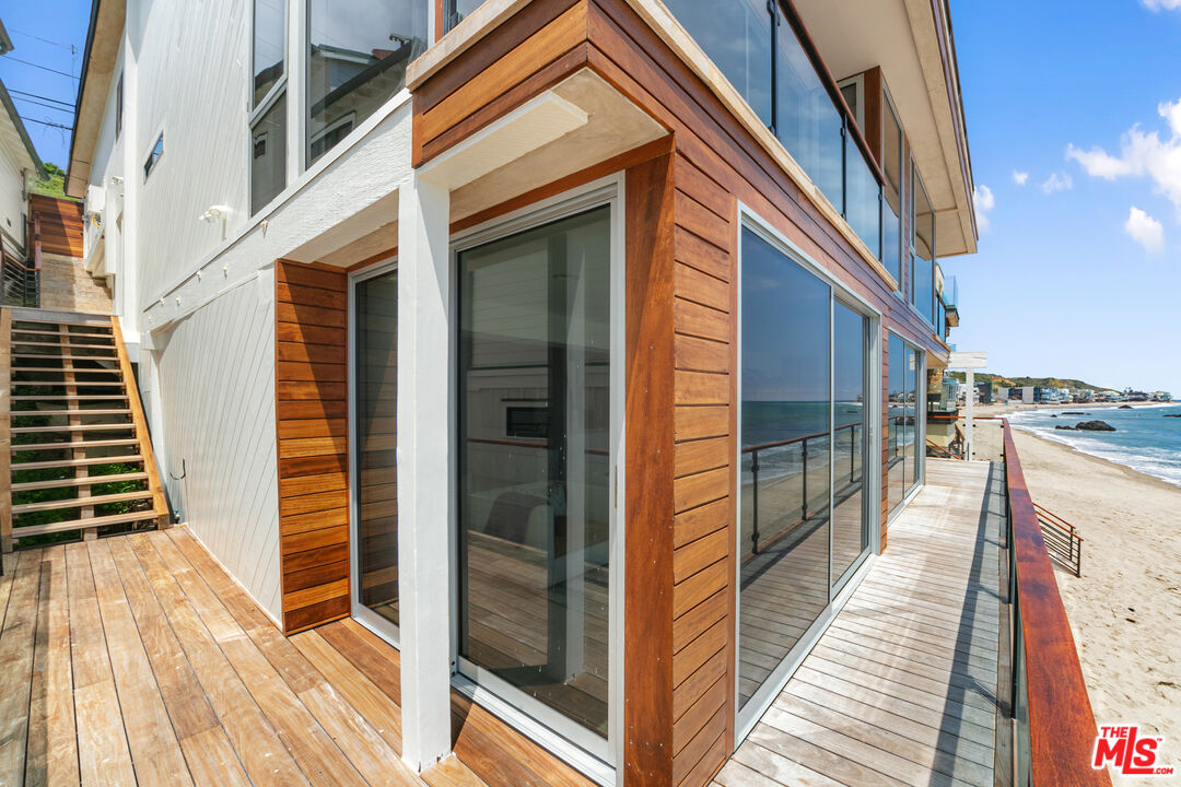 24928 Malibu Road Malibu, CA 90265 - Photo 43 of 50 a view of a balcony with wooden floor and door
