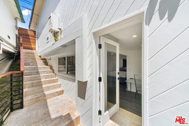 a kitchen with granite countertop a refrigerator stove and wooden floor