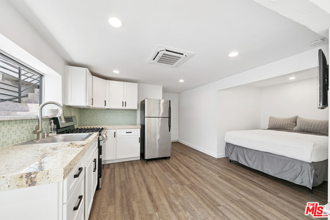 24928 Malibu Road Malibu, CA 90265 - Photo 45 of 50 a kitchen with a sink a counter top space stainless steel appliances and cabinets