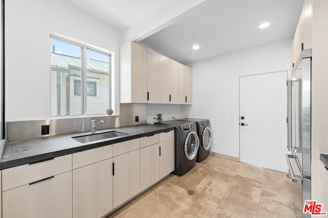 24928 Malibu Road Malibu, CA 90265 - Photo 48 of 50 a kitchen with stainless steel appliances granite countertop a sink a stove and a refrigerator