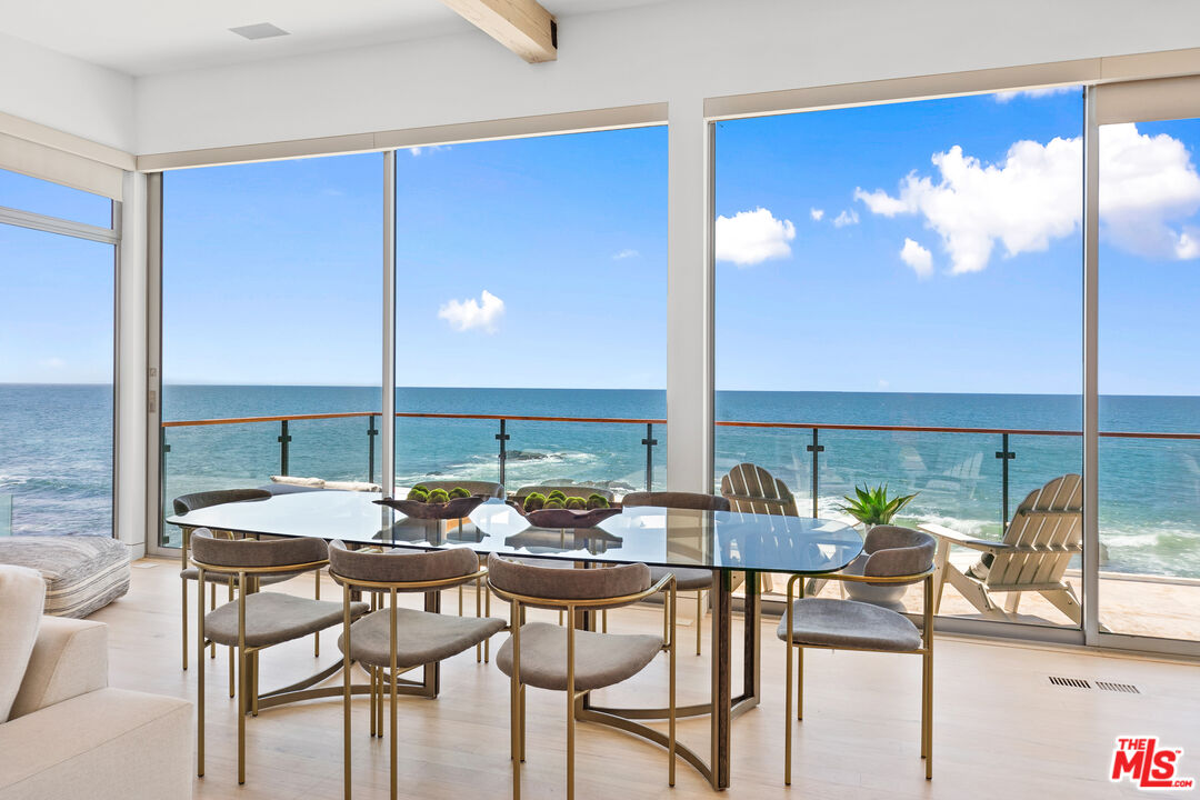 24928 Malibu Road Malibu, CA 90265 - Photo 7 of 50 a view of a dining room with furniture and floor to ceiling window