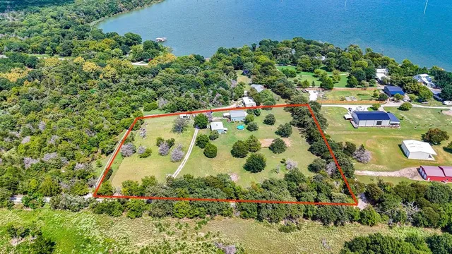 a view of a house with a backyard and a tree