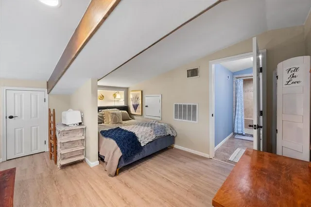 a bedroom with a large bed and a window