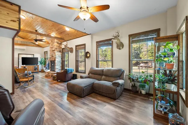 a living room with furniture a flat screen tv and a fireplace