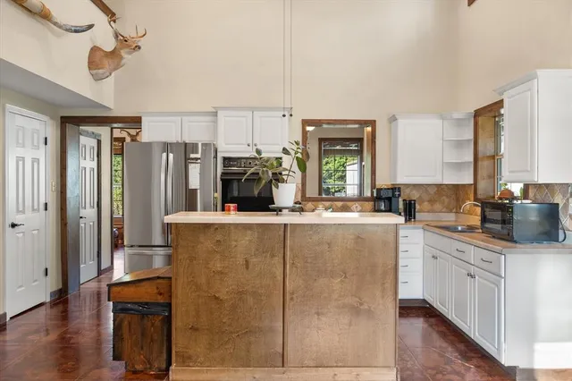 a kitchen with granite countertop a stove microwave and sink