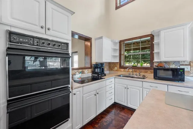 a kitchen with a sink and a large window