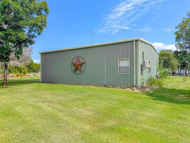 a front view of house with backyard