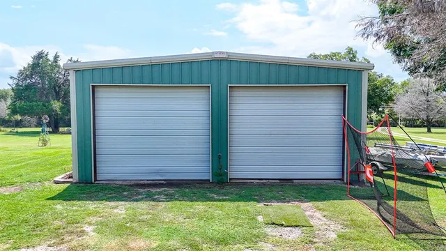 a backyard of a house with table and chairs