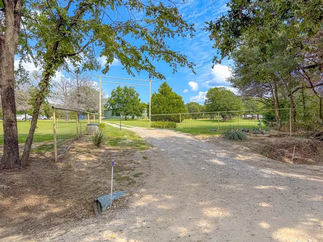 a view of a lake with houses in back