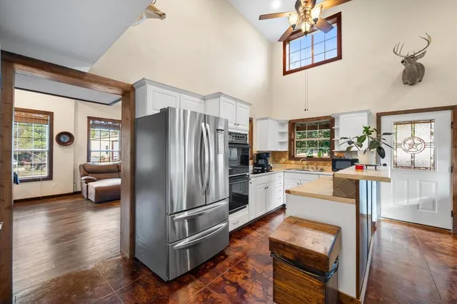 a living room with furniture a fireplace and a floor to ceiling window