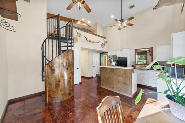 a spacious bedroom with a bed and a dresser