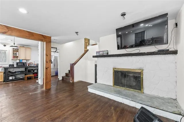 a view of a hallway view with wooden floor and staircase