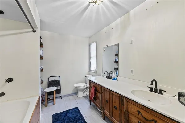 a bathroom with a sink a toilet and mirror