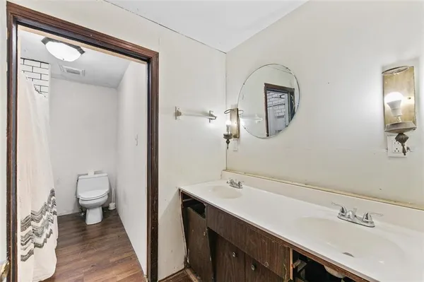 a bathroom with a toilet and a shower curtain
