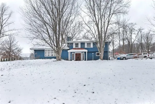 a view of a house with a snow in the yard