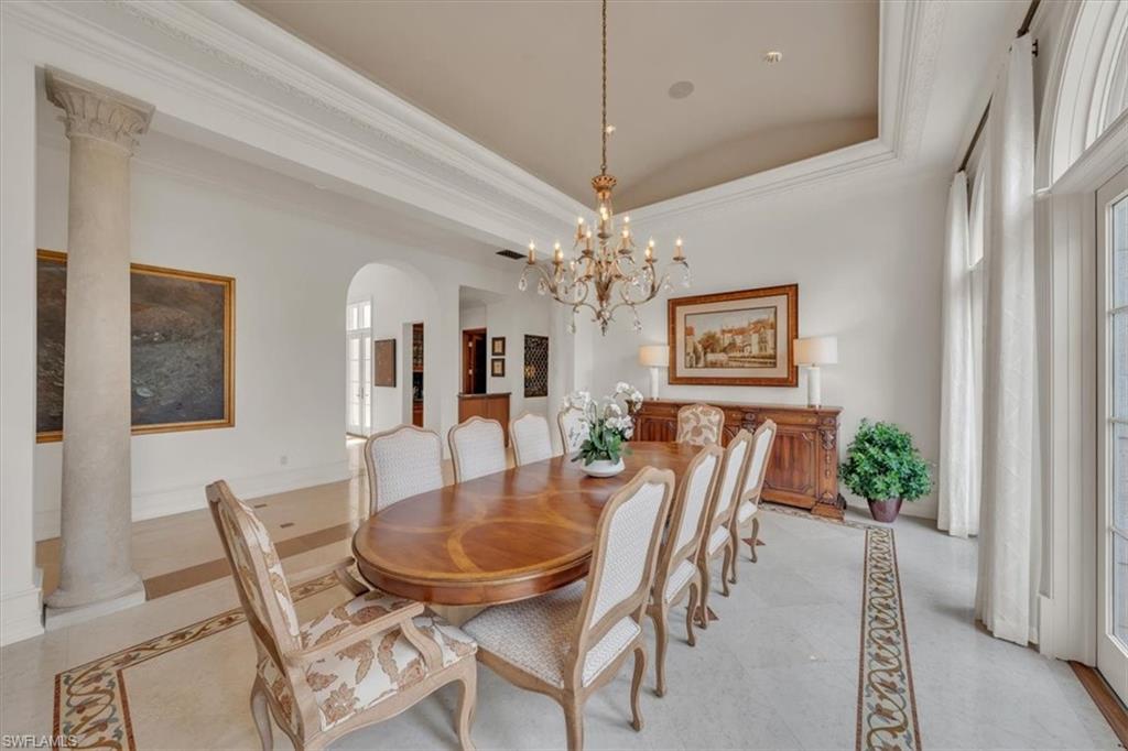 2116 Canna Way Naples, FL 34105 - Photo 12 of 50 a dining room with furniture a chandelier and wooden floor