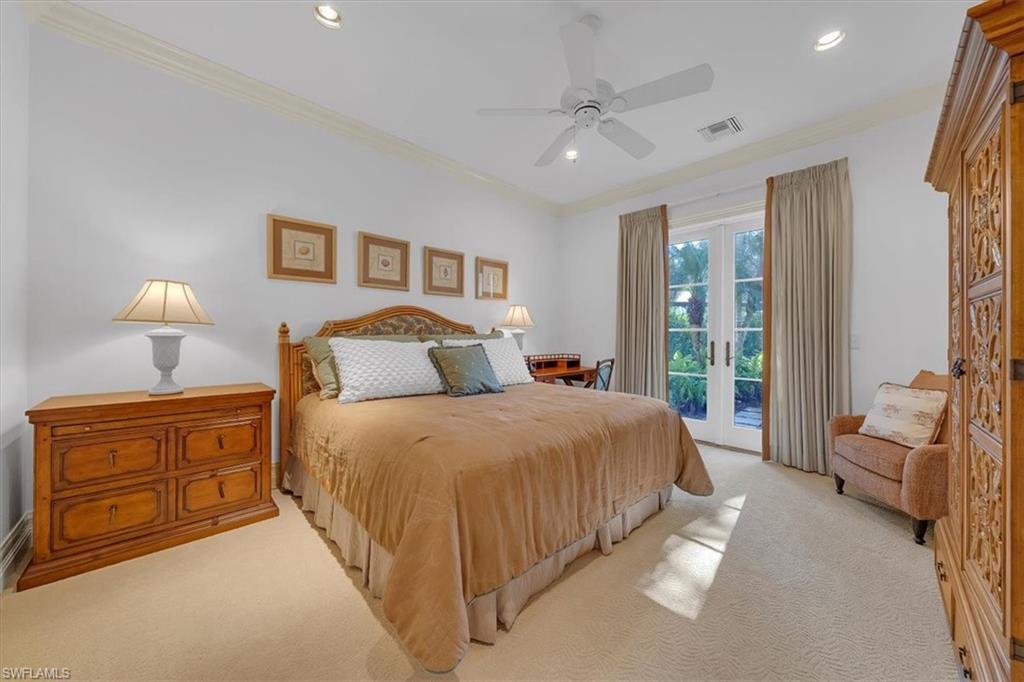 2116 Canna Way Naples, FL 34105 - Photo 27 of 50 a bedroom with a bed and a chandelier