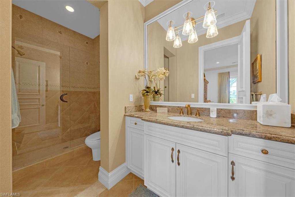 2116 Canna Way Naples, FL 34105 - Photo 28 of 50 a bathroom with a granite countertop sink a toilet and shower
