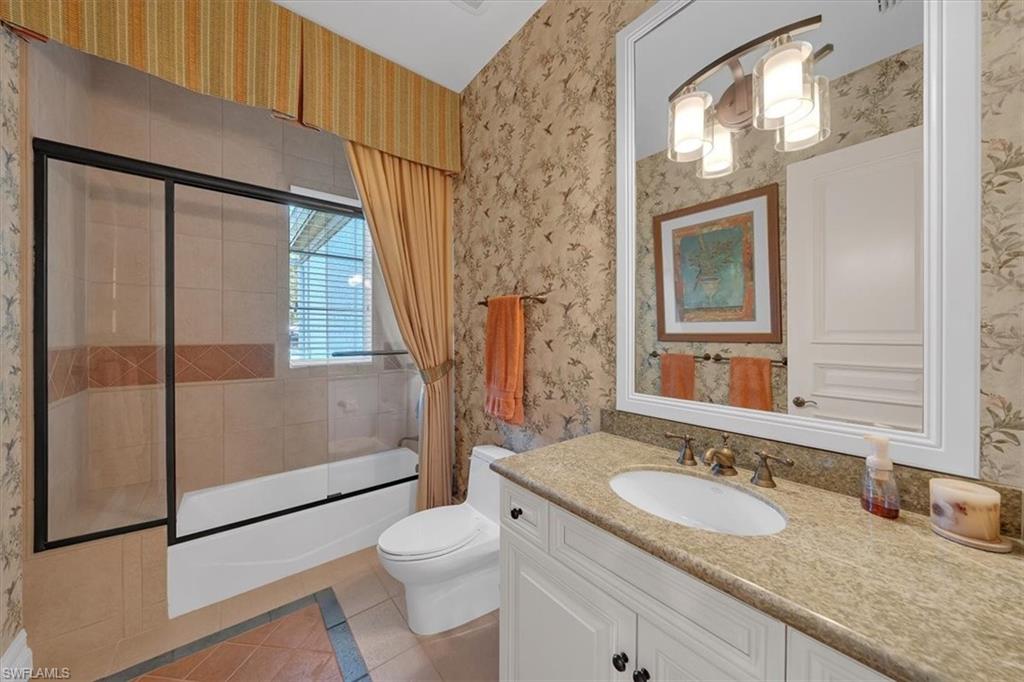 2116 Canna Way Naples, FL 34105 - Photo 30 of 50 a bathroom with a granite countertop sink toilet and shower
