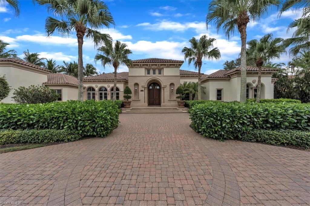 2116 Canna Way Naples, FL 34105 - Photo 4 of 50 a front view of a house with a garden
