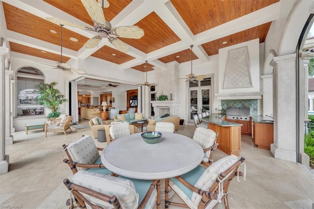 2116 Canna Way Naples, FL 34105 - Photo 41 of 50 a dining room with furniture and wooden floor