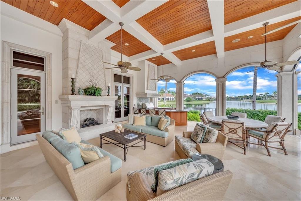 2116 Canna Way Naples, FL 34105 - Photo 42 of 50 a living room with fireplace furniture and a large window