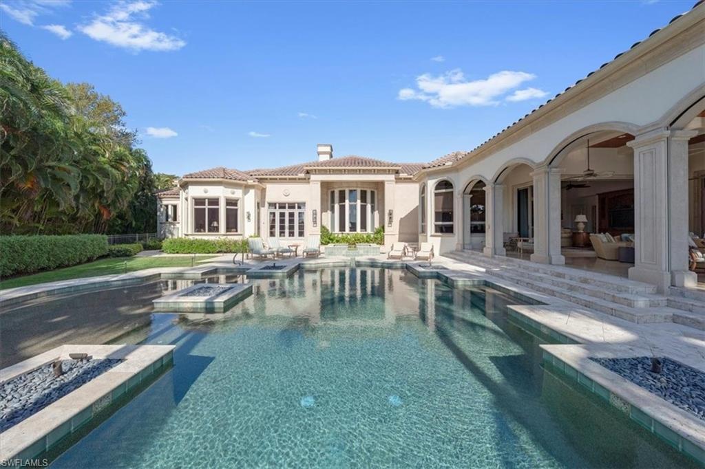 2116 Canna Way Naples, FL 34105 - Photo 45 of 50 a view of a house with pool patio and a yard