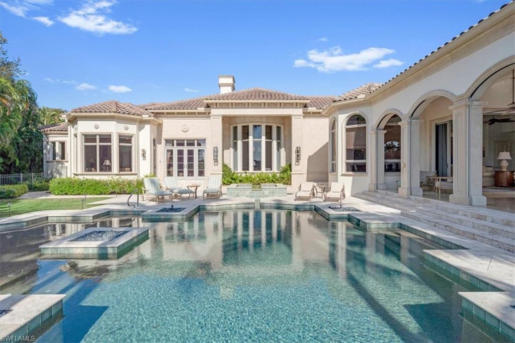 2116 Canna Way Naples, FL 34105 - Photo 46 of 50 a view of a patio with couches table and chairs with plants and trees