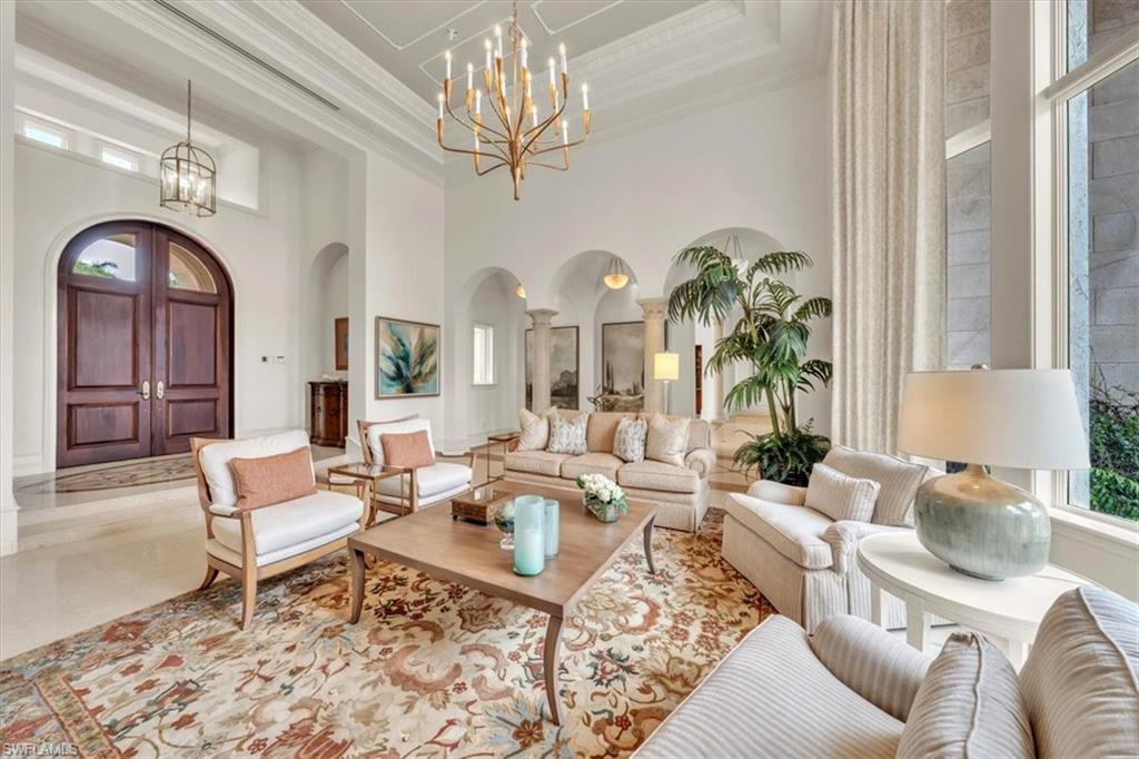 2116 Canna Way Naples, FL 34105 - Photo 8 of 50 a living room with furniture chandelier and a chandelier