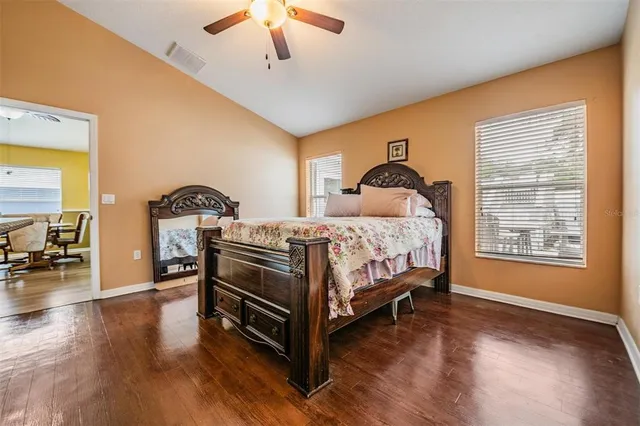 a bedroom with a bed and wooden floor