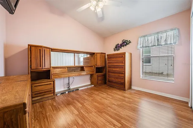 a view of a bedroom with furniture and windows