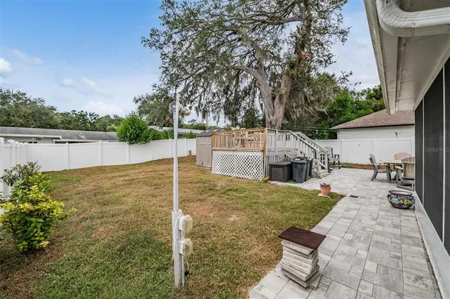 a backyard of a house with table and chairs