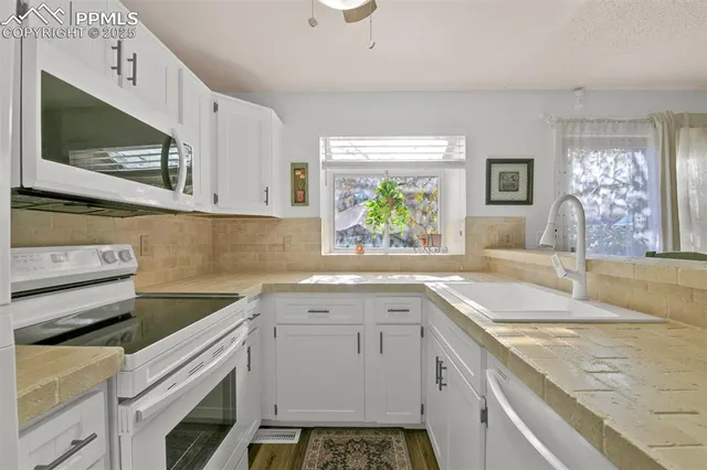 a kitchen with a sink stove and microwave