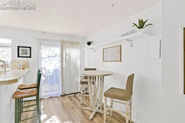 a view of a workspace with furniture and wooden floor