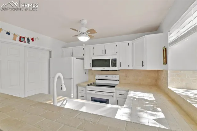 a kitchen with stainless steel appliances kitchen island granite countertop a refrigerator and a stove top oven