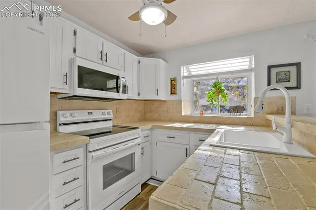 a kitchen with a stove a sink and a microwave