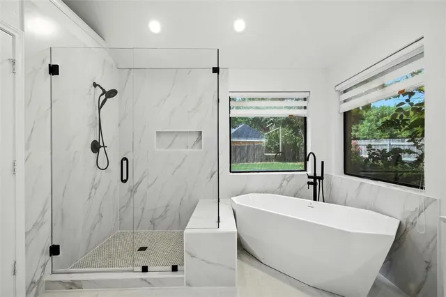 a spacious bathroom with a tub shower and sink