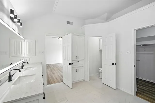 a white refrigerator freezer and a wooden floor