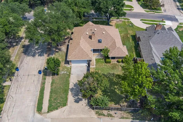 an aerial view of residential houses with outdoor space and river