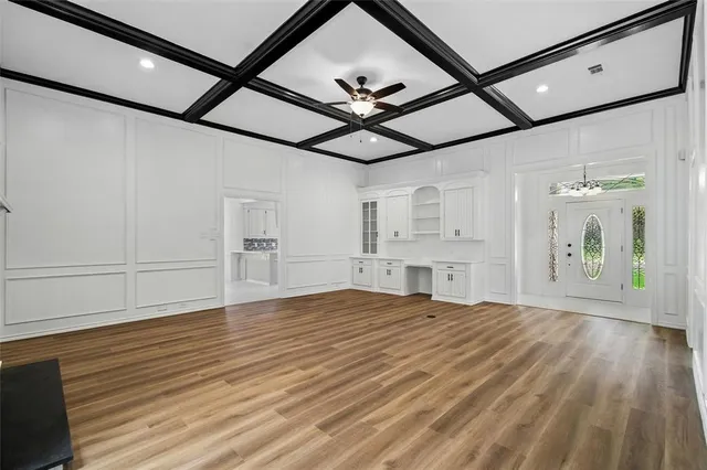 a view of empty room with wooden floor and fireplace